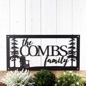 Rectangular family name metal sign with Adirondack chair and fir pine trees, in matte black powder coat.