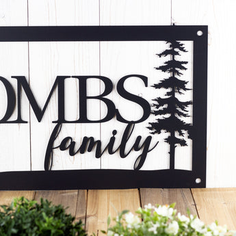 Close up of family word on our rectangular metal name sign, in matte black powder coat.