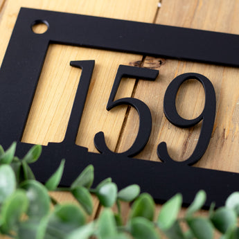 Close up of matte black powder coat on our rectangular metal address plaque.