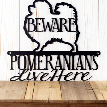Close up of Pomeranians Live Here wording on our Pomeranian metal wall art, in matte black powder coat. 