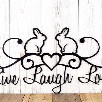 Close up of rabbit silhouettes and heart on our Live Laugh Love metal wall decor, in matte black powder coat. 