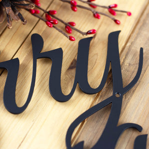 Close up of matte black powder coat on our Merry Christmas script sign. 