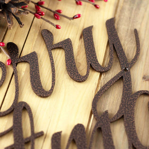 Close up of copper vein powder coat on our Merry Christmas script sign.