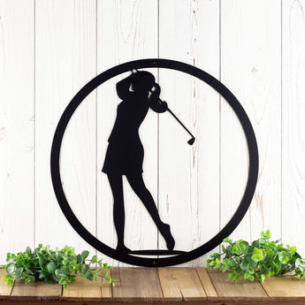 Circular woman golfer metal wall art, in matte black powder coat.