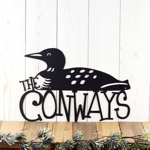Personalized family name metal sign with loon silhouette, in matte black powder coat.