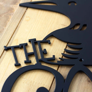 Close up of matte black powder coat for our personalized loon family name metal sign.