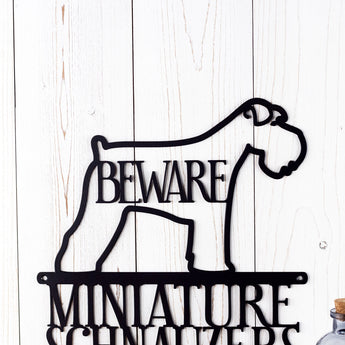 Close up of Miniature Schnauzer dog silhouette with Beware in the center, on our metal sign, in matte black powder coat. 