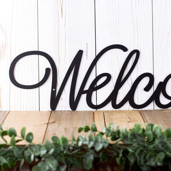 Close up of Welcome script lettering on our Welcome metal plaque, in matte black powder coat.