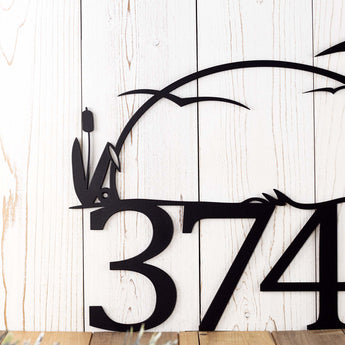 Close up of cattails on our Heron metal house number sign, in matte black powder coat.