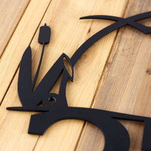 Close up of matte black on our Heron & Cattails metal house number sign.