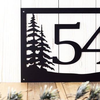 Close up of 2 digit rectangular metal house number sign with pine trees, in matte black powder coat.