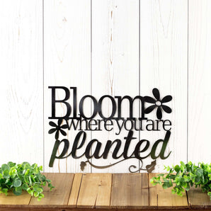Bloom where you are planted metal wall art with flowers and vines, in raw steel. 
