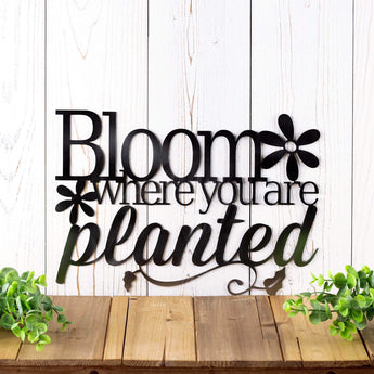 Bloom where you are planted metal wall art with flowers and vines, in raw steel.