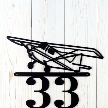 Close up of airplane silhouette on our metal house number sign, in matte black powder coat.