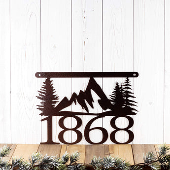 Hanging 4 digit metal house number sign with mountains and pine trees, in copper vein powder coat. 