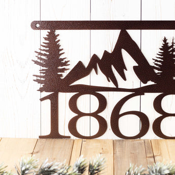 Close up of our 4 digit mountain metal house number sign, in copper vein powder coat.