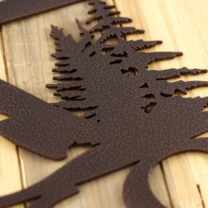 Close up of copper vein powder coat on our hanging metal house number sign with pine trees and mountains.