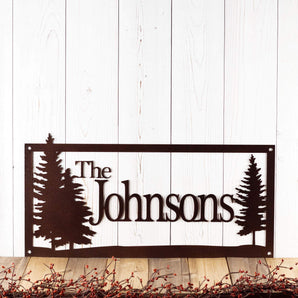 Rectangular personalized family last name metal sign with pine trees, in copper vein powder coat. 