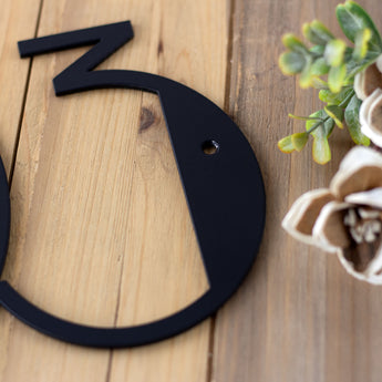 Close up of matte black powder coat on our modern metal house number sign.