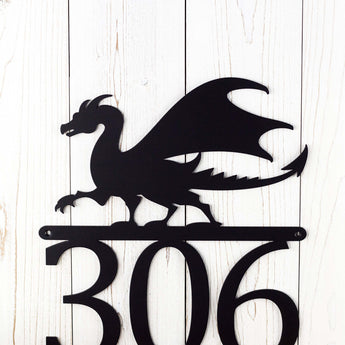 Close up of a dragon silhouette on our 3 digit metal house number sign, in matte black powder coat. 