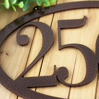 Close up of copper vein powder coat from our horizontal oval 4 digit metal house number sign.