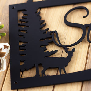 Close up of doe deer on our metal family name sign, in matte black powder coat.