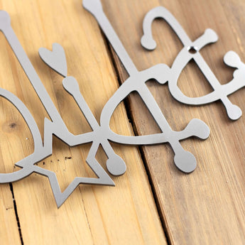 Close up of raw steel powder coat on our Happy Holidays metal wall art. 
