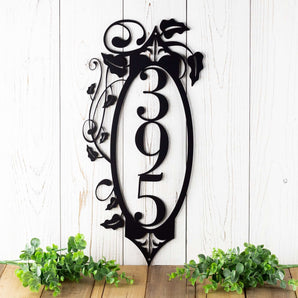 3 digit vertical metal house number sign with vines and fleur de lis, in matte black powder coat. 