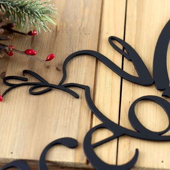 Close up of matte black coat on our Peace on Earth metal wall art. 