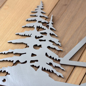 Close up of raw steel on our metal house number sign with pine trees. 