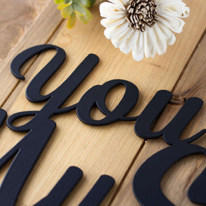 Close up of matte black powder coat on our You Are My Sunshine metal sign.