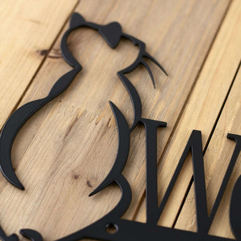 Close up of Welcome text on our cat welcome metal sign, in matte black powder coat. 