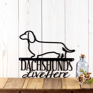 Dachshunds Live Here metal sign, in matte black powder coat.
