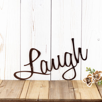 Close up of script Laugh word on our Live Laugh Love metal signs, in copper vein powder coat.