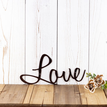 Close up of script Love word on our Live Laugh Love metal wall art, in copper vein powder coat. 