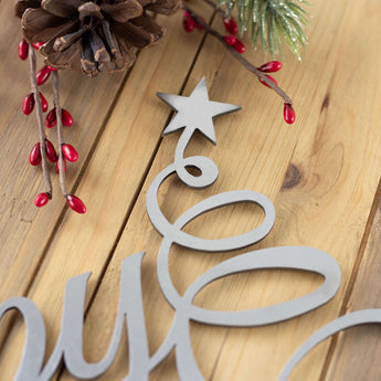 Close up of raw steel on our Happy Holidays metal wall art. 