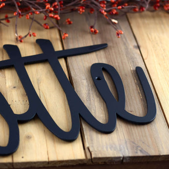 Close up of matte black powder coat on our personalized metal sign.