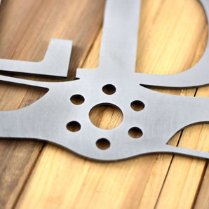 Close up of pilot family name metal sign with propeller, in raw steel. 