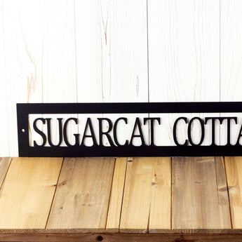 Close up of our hanging rectangular personalized lake house metal wall decor, in matte black powder coat.