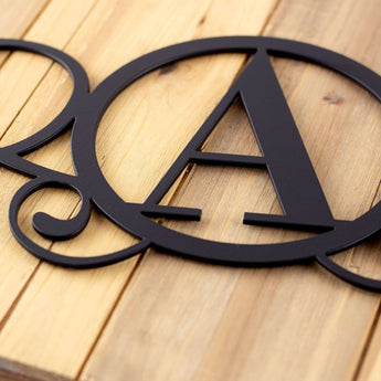 Close up of matte black powder coat on our metal monogram sign.