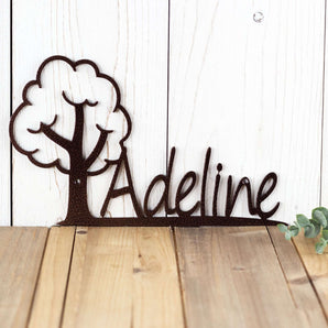 Close up of our boy or girl metal name sign with cute tree silhouette, in copper vein powder coat.