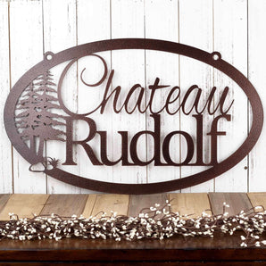 Oval custom metal family name sign with pine trees, in copper vein powder coat.
