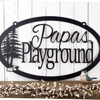 Oval custom metal family name sign with pine trees, in matte black powder coat.