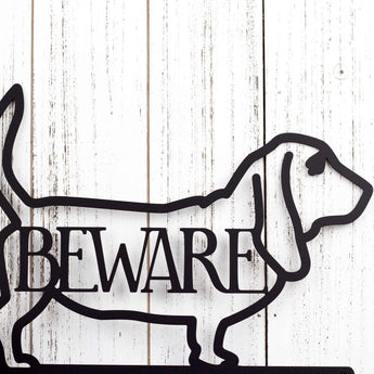 Close up of Basset hound silhouette with beware, in matte black powder coat. 