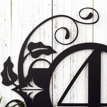 Close up of vines and fleur de lis on our 1 digit metal house number sign, in matte black powder coat.