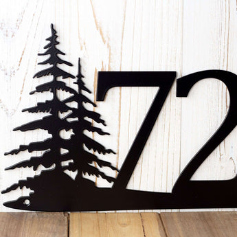 Close up of pine tree silhouette on our metal house number sign, in matte black powder coat.