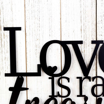 Close up of Love word on our Love is Rare Treasure It metal sign, in matte black powder coat. 