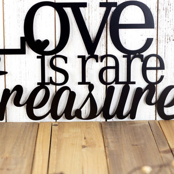 Close up of treasure word on our Love is Rare Treasure It metal wall decor, in matte black powder coat. 