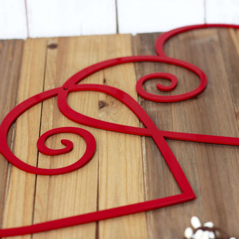 Close up of red gloss powder coat on our curly hearts metal sign.