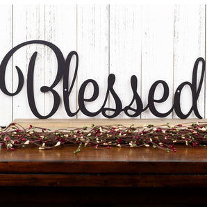 Blessed metal wall decor, in matte black powder coat.
